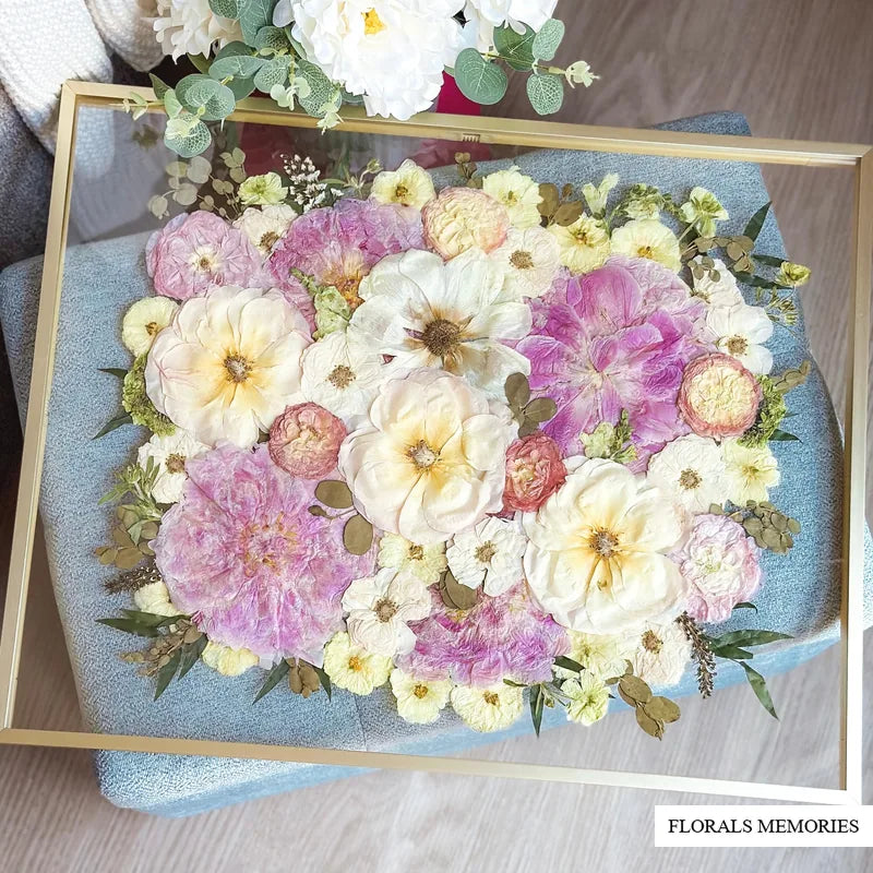 Pressed wedding bouquet flowers arranged in a gold glass frame keepsake