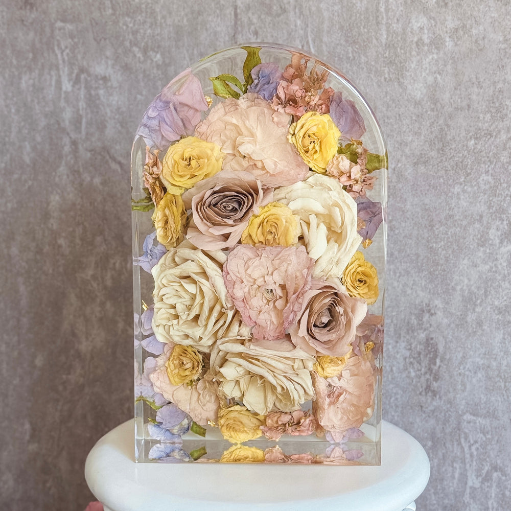 Golden resin arch keepsake made from a preserved wedding bouquet